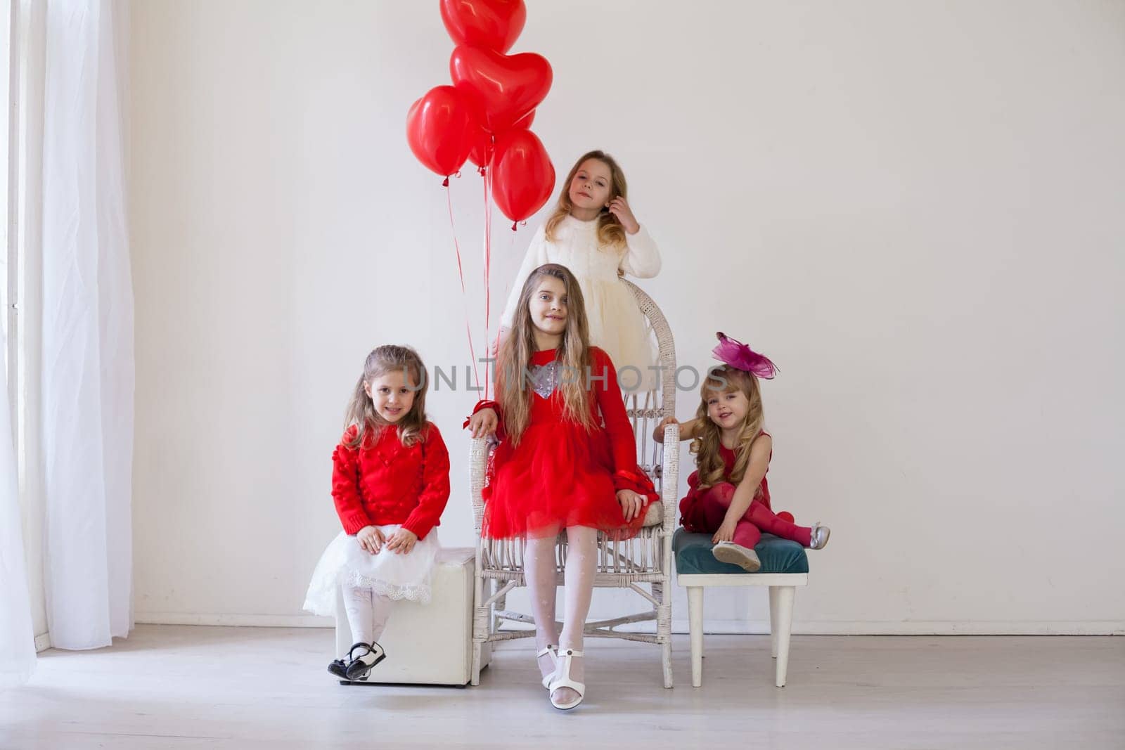 Girls with red heart-shaped balloons on birthday