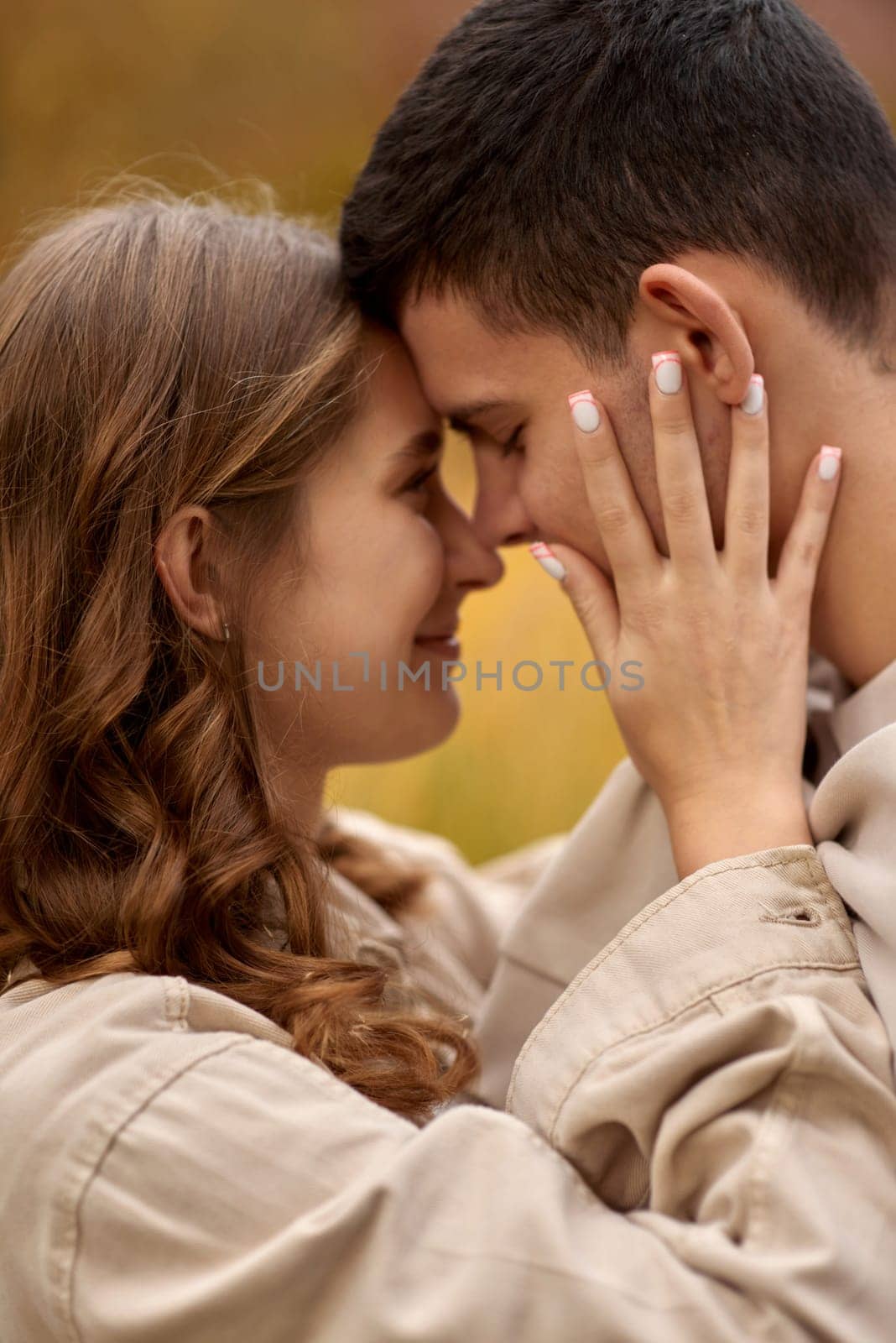 Young Cute Female Hugs Boyfriend. In Autumn Outdoor. Lovers Walking in Park. Attractive Funny Couple. Lovestory in Forest. Man and Woman. Cute Lovers in the Park. Family Concept. Happy Couple.