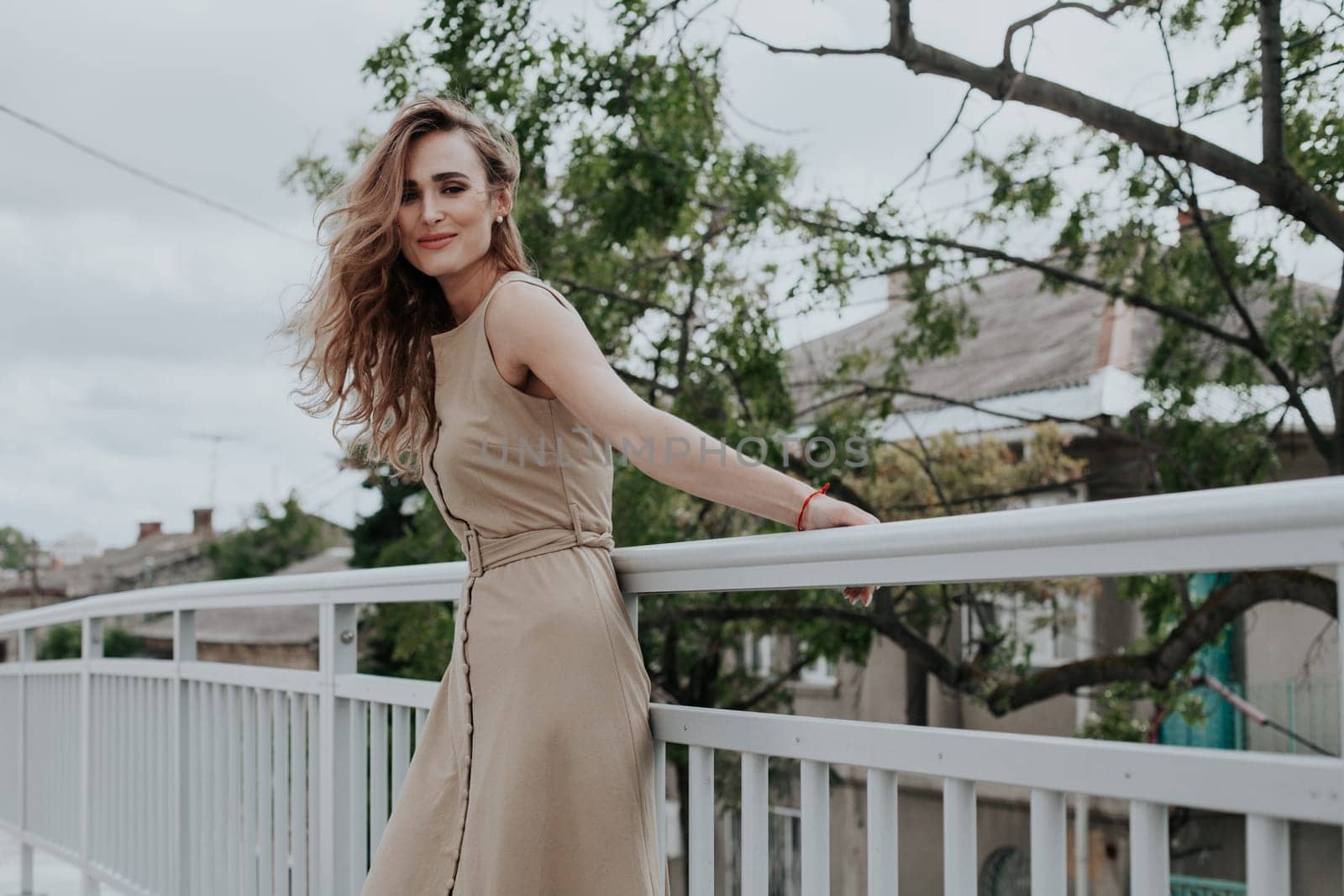 Portrait of a beautiful blonde woman in a beige dress