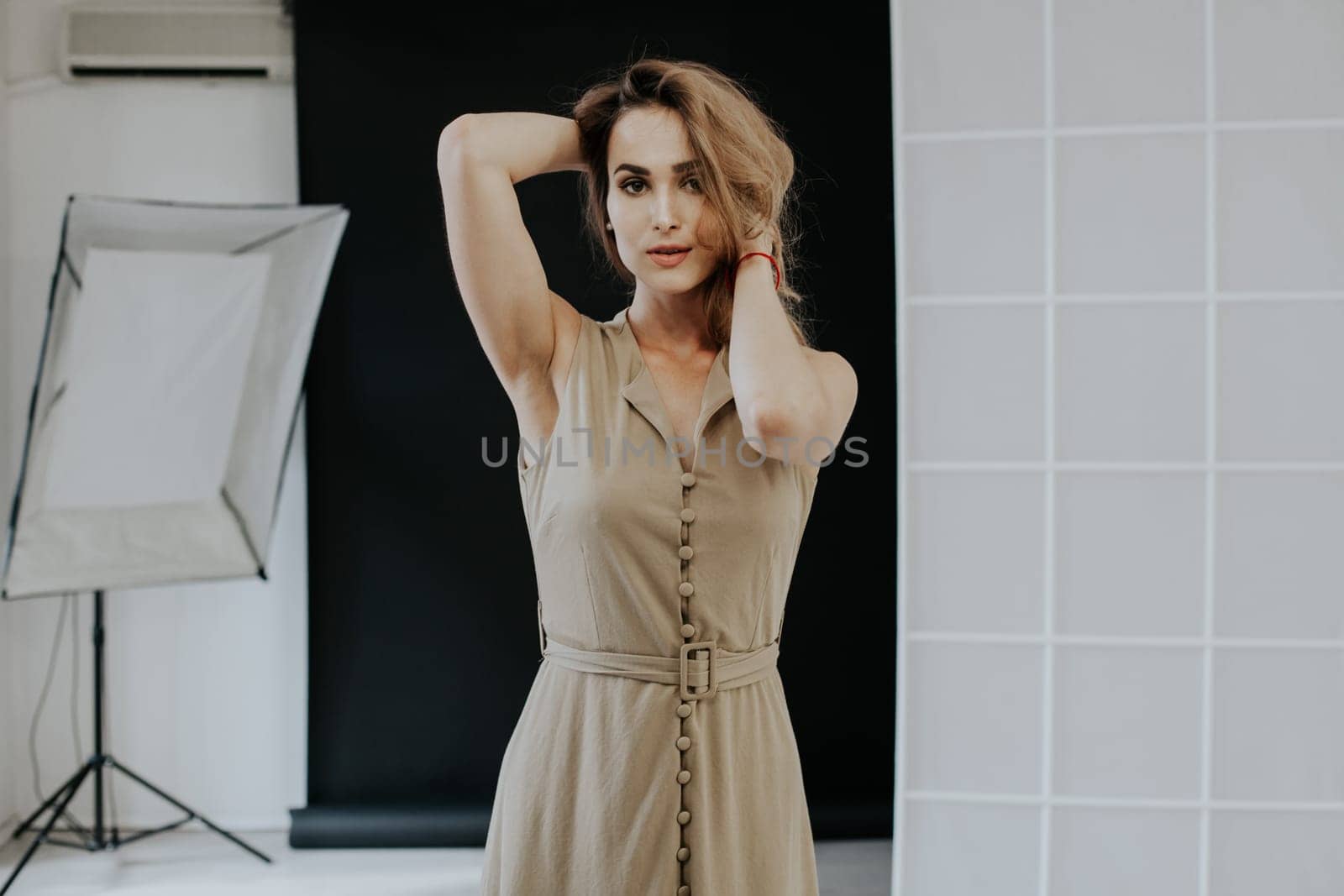 Portrait of a beautiful blonde woman in a beige dress