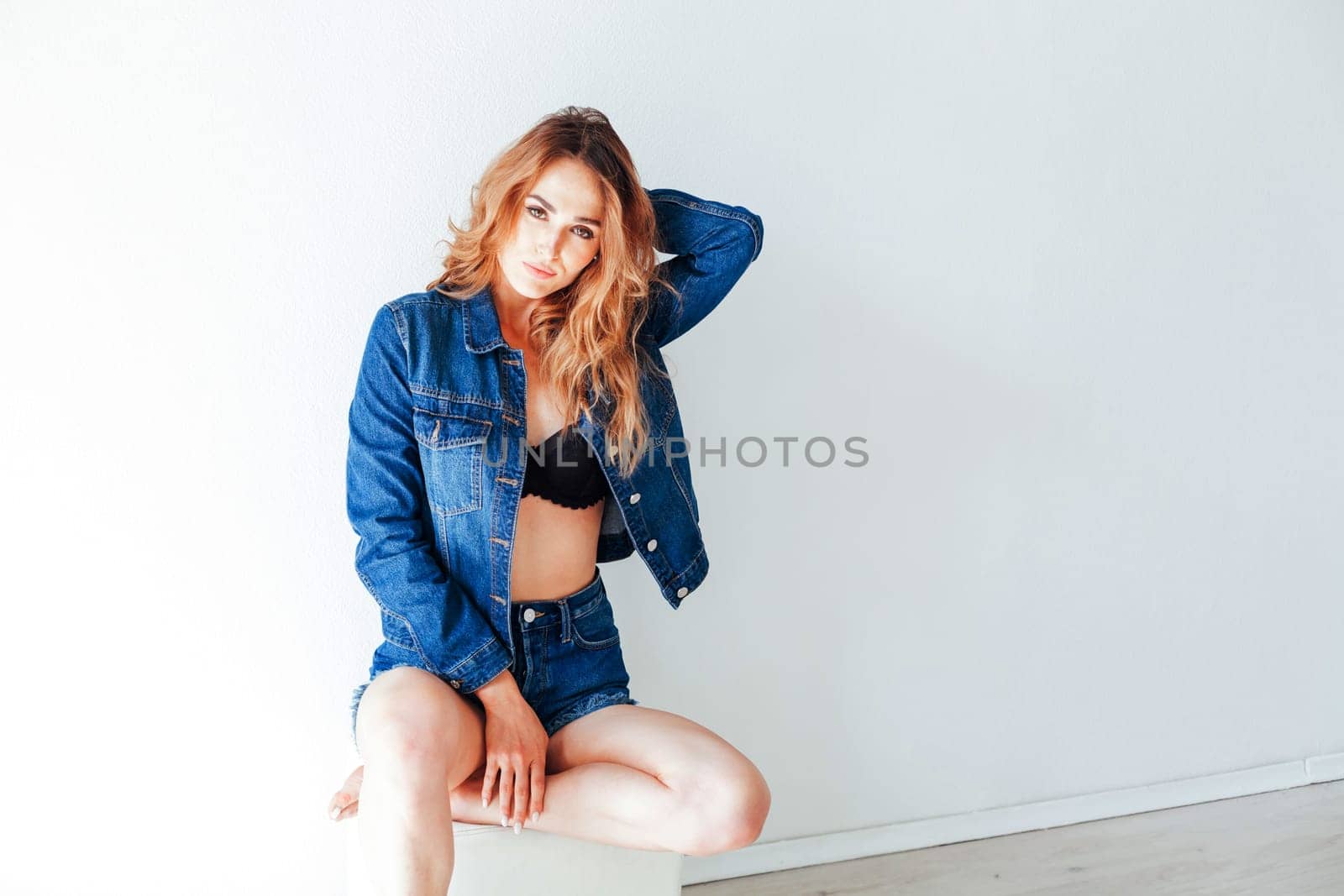 Portrait of a beautiful fashionable woman in lingerie and jeans by Simakov