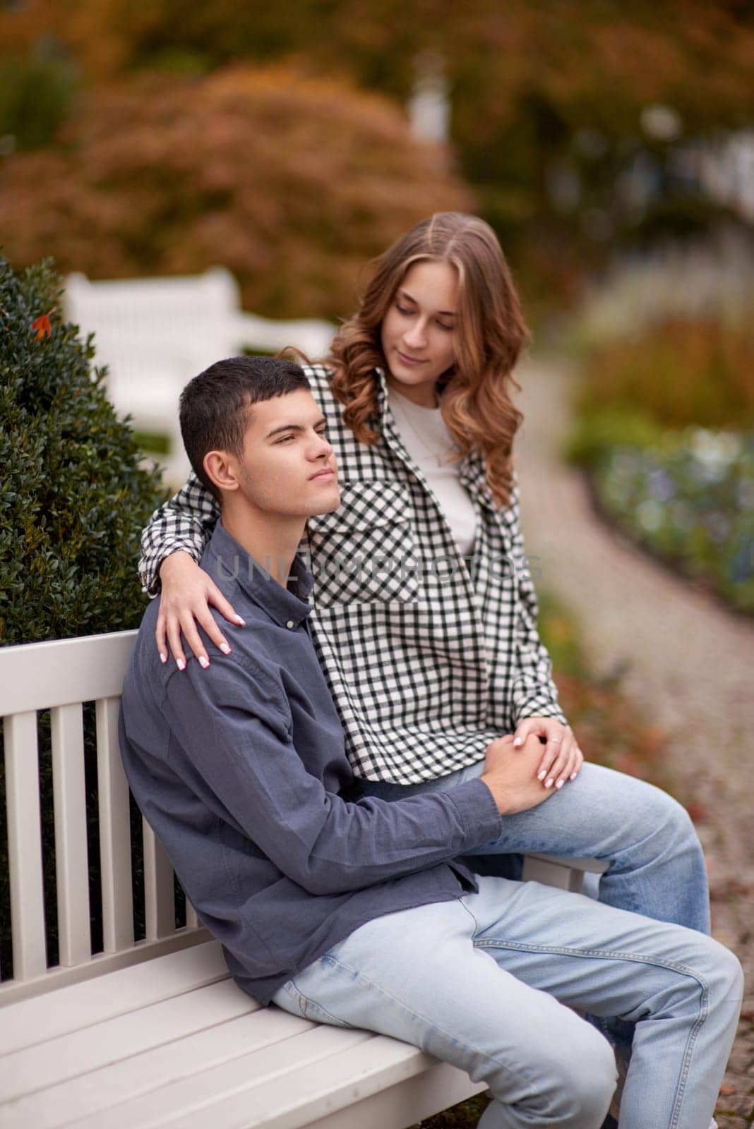 Autumn Romance: Young Couple Embracing and Kissing on Park Bench. Young couple kissing and rejoices at the lake. lovely young couple kissing outdoors in autumn. Embraced in Autumn's Warmth: Couple's Kiss on Park Bench. Loving couple walking in nature. Autumn mood. Happy man and woman hugging and kissing in autumn. Love. Fashionable couple outdoors. Fashion, people and lifestyle. Stylish couple in autumn outfit. by Andrii_Ko