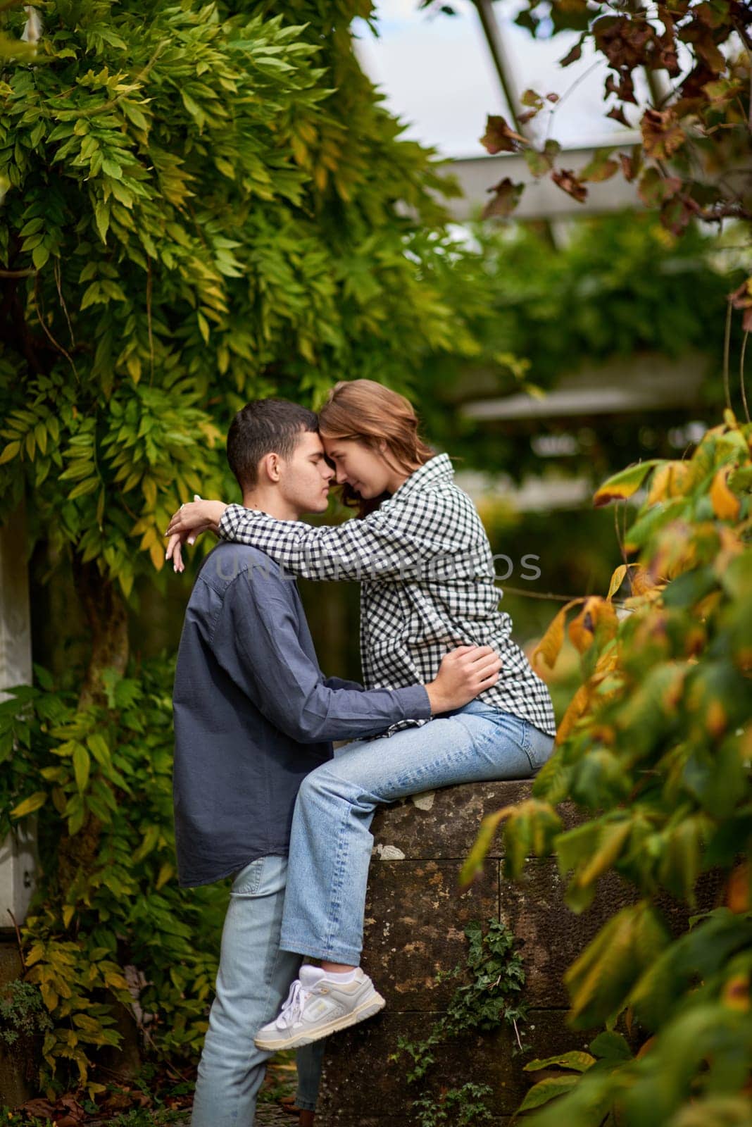 Young Cute Female Hugs Boyfriend. In Autumn Outdoor. Lovers Walking in Park. Attractive Funny Couple. Lovestory in Forest. Man and Woman. Cute Lovers in the Park. Family Concept. Happy Couple.