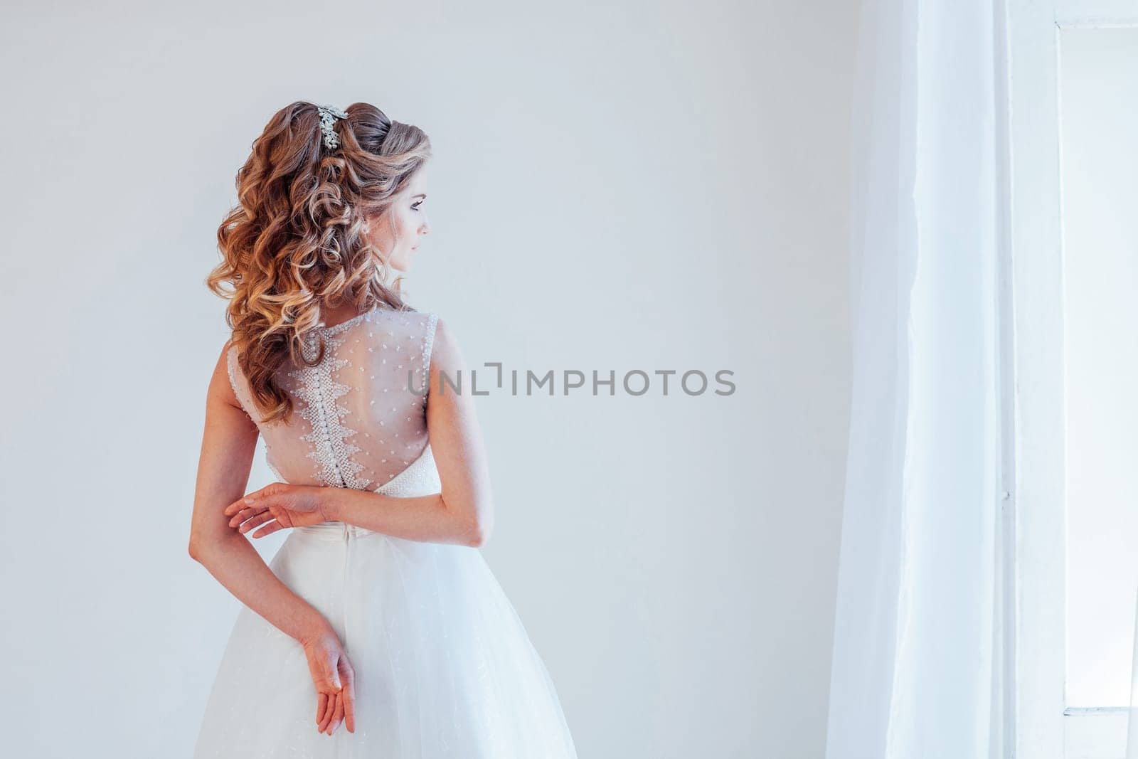 spin the bride in a wedding dress in a white room by Simakov