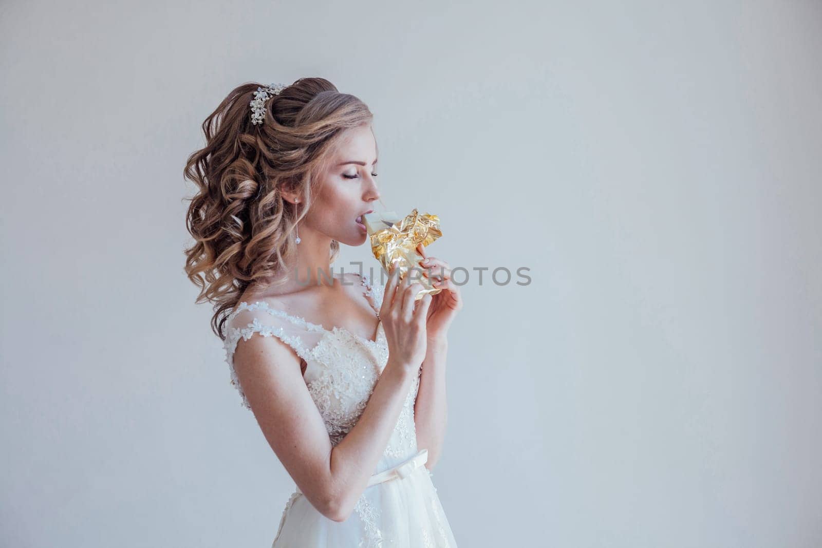 the bride at a wedding in a room eating white chocolate