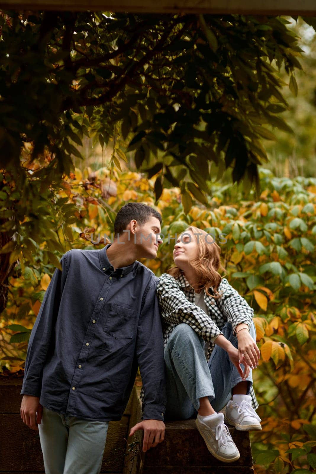 Young Cute Female Hugs Boyfriend. In Autumn Outdoor. Lovers Walking in Park. Attractive Funny Couple. Lovestory in Forest. Man and Woman. Cute Lovers in the Park. Family Concept. Happy Couple.