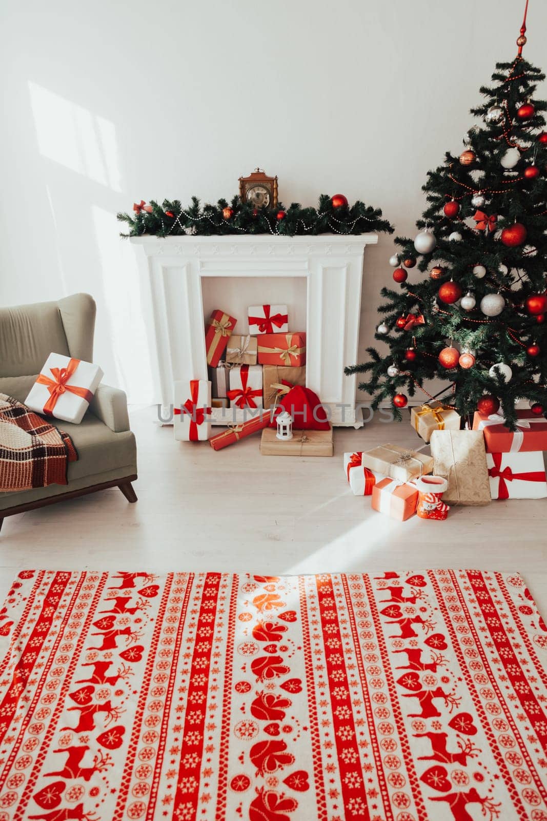 Christmas tree with gifts in the interior of the white room decor for the new year