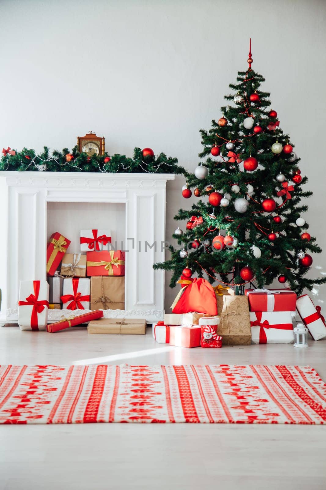 Christmas tree with gifts in the interior of the white room decor for the new year