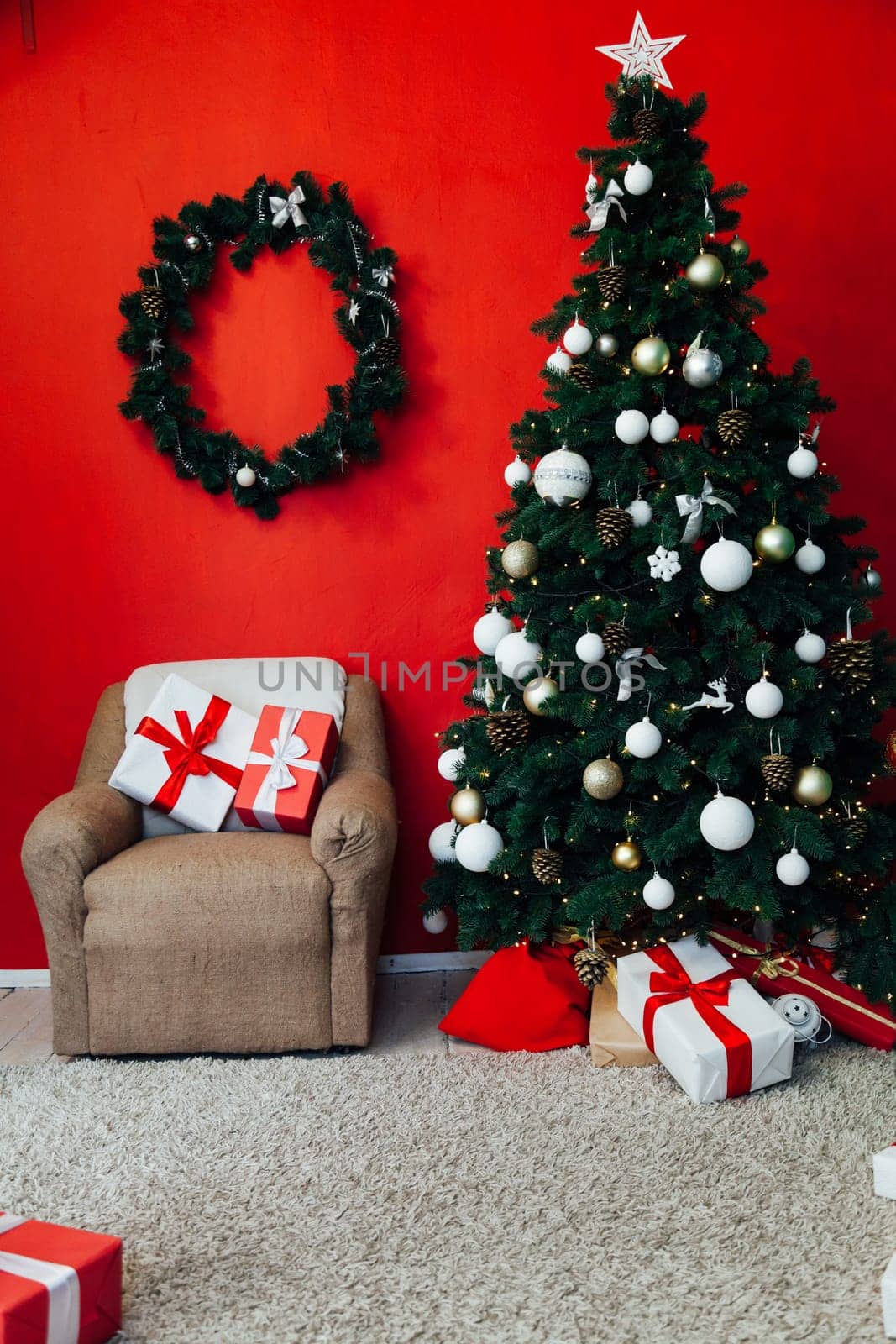 Christmas tree with gifts in the interior of the red room decor for the new year