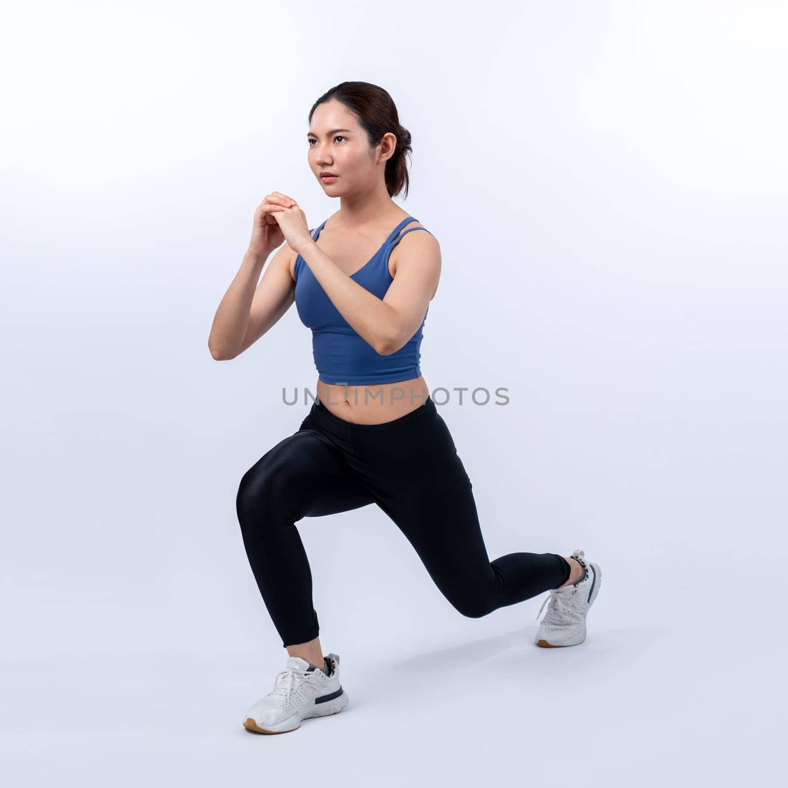 Young attractive asian woman in sportswear stretching before fitness exercise routine. Healthy body care workout with athletic woman warming up on studio shot isolated background. Vigorous