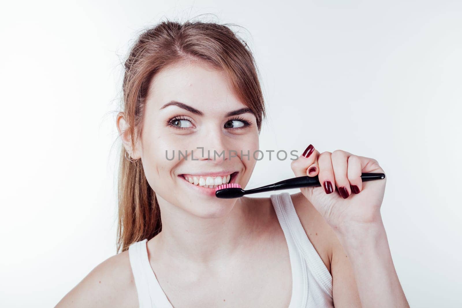 beautiful girl cleans white teeth toothbrush smile by Simakov