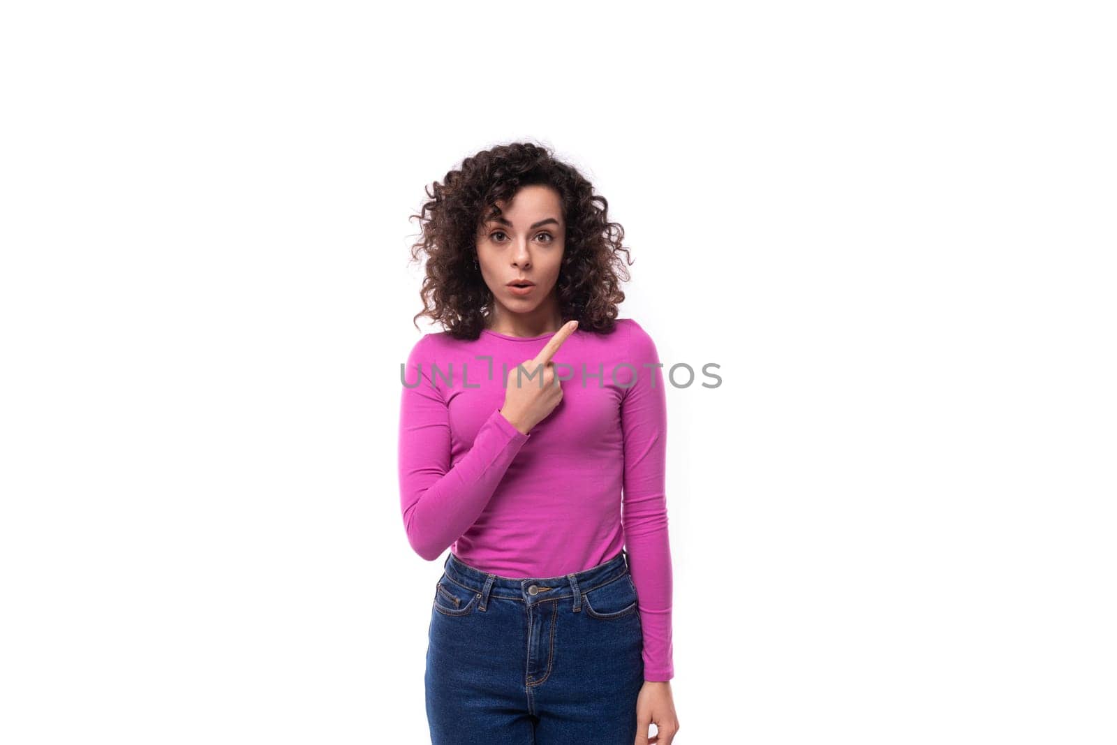 young curly brunette lady is dressed in a trendy lilac turtleneck on a white background by TRMK