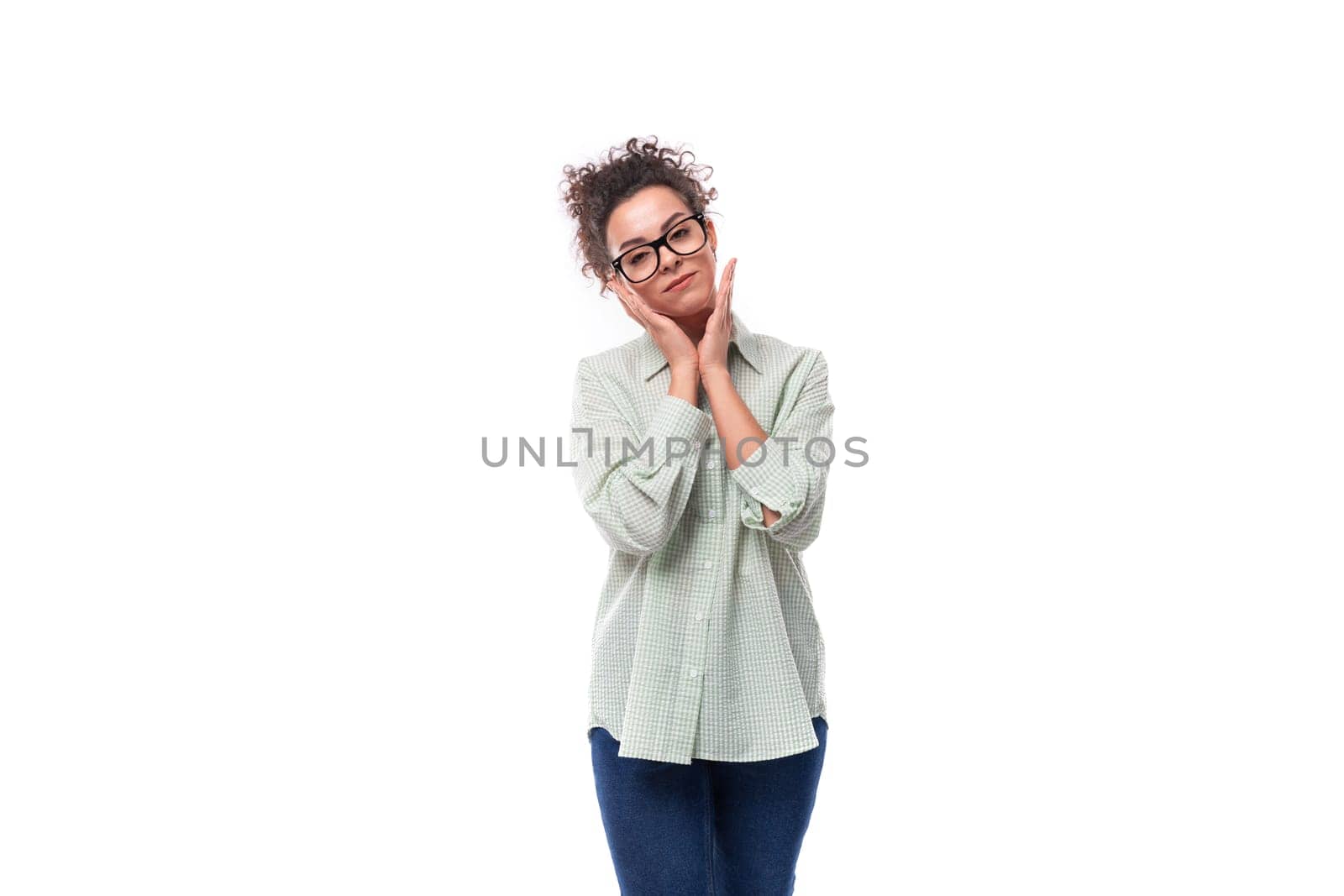 young leader woman with curly black hair in glasses dressed in a shirt on a white background.