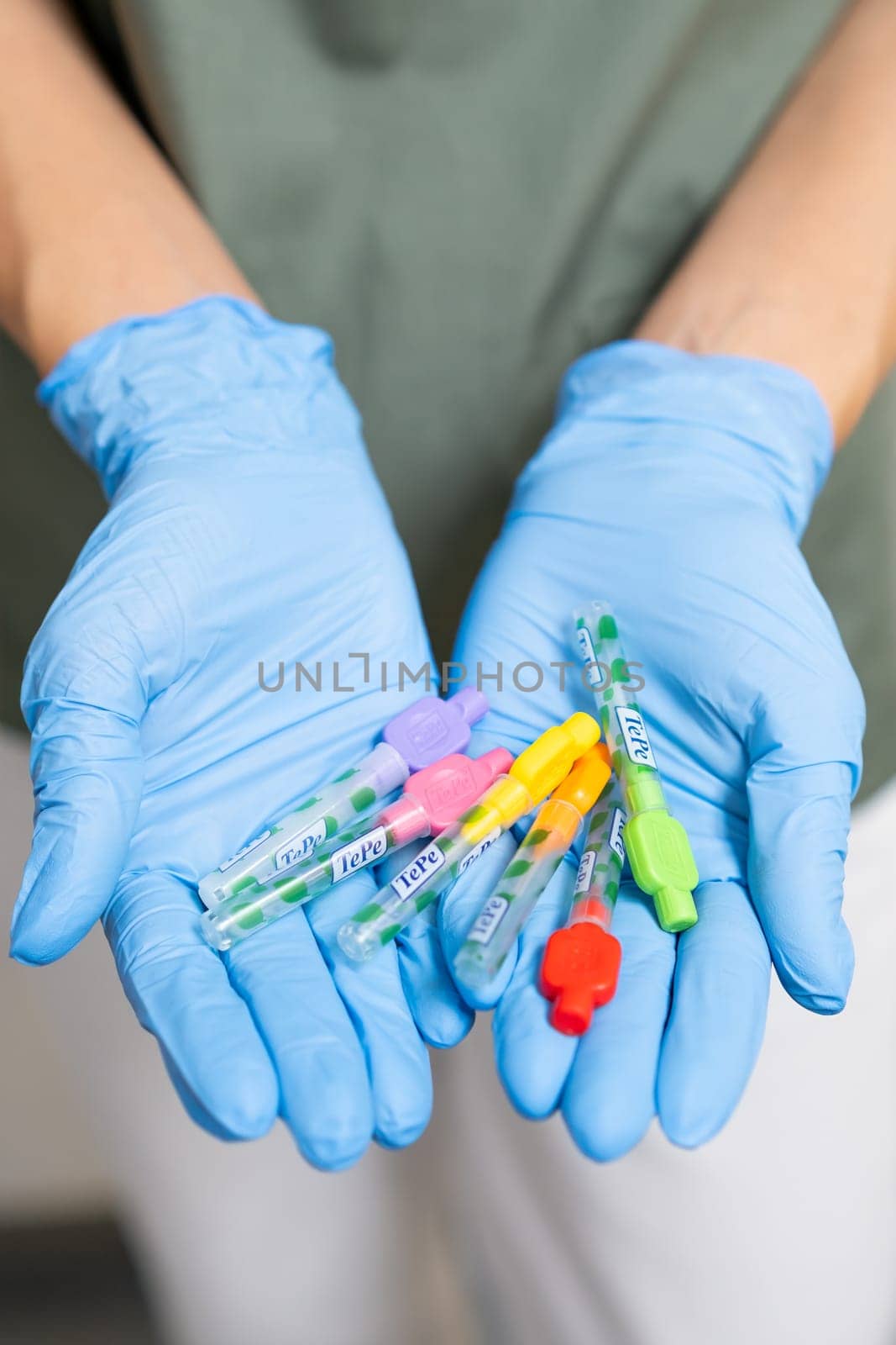 Interdental Toothbrushes in dentists hands in rubber gloves. December 2023, Prague, Czech Republic