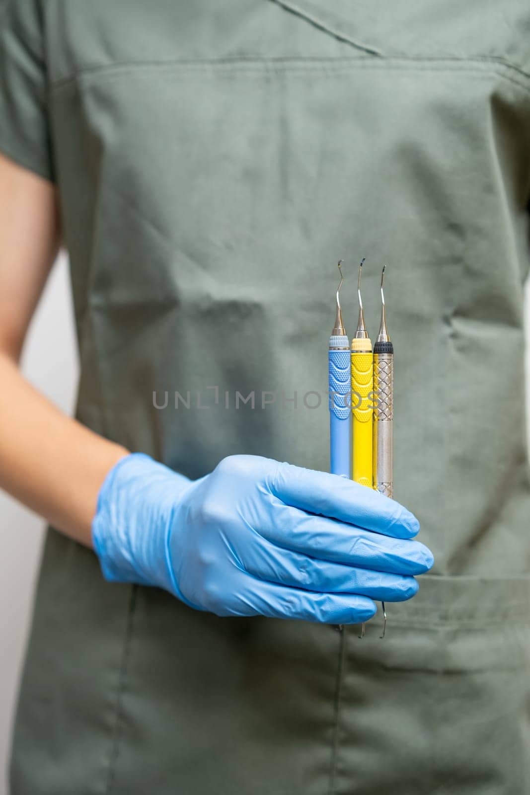 Dental probes in dentists hand in rubber gloves. by vladimka
