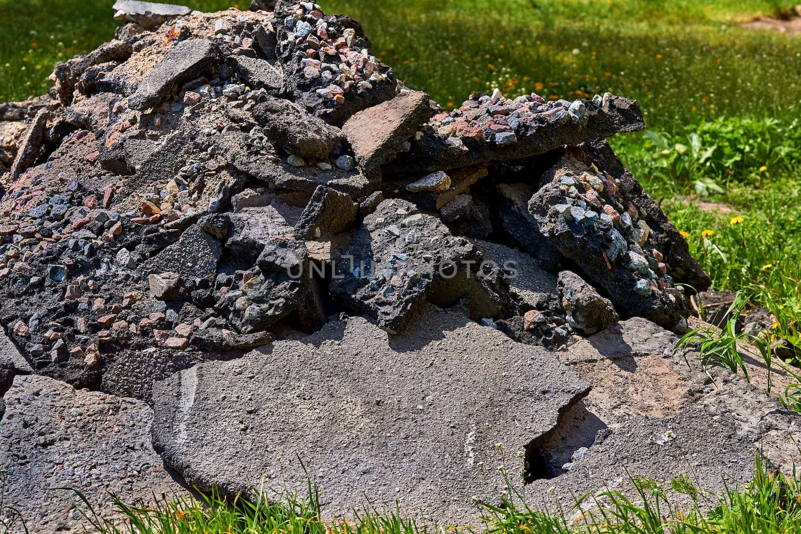 A pile of old broken asphalt with rubble left after the repair of the road by jovani68