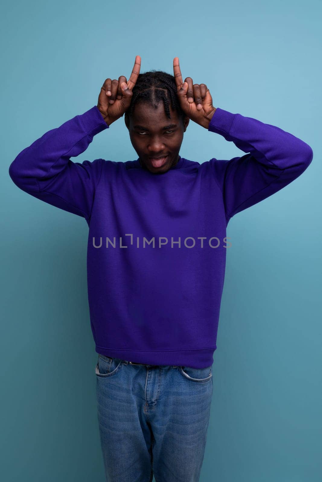 funny american young man with dreadlocks in a blue sweatshirt.