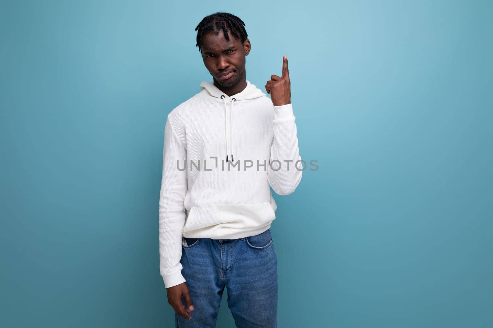 smart black american young man with dreadlocks showing thumbs up by TRMK