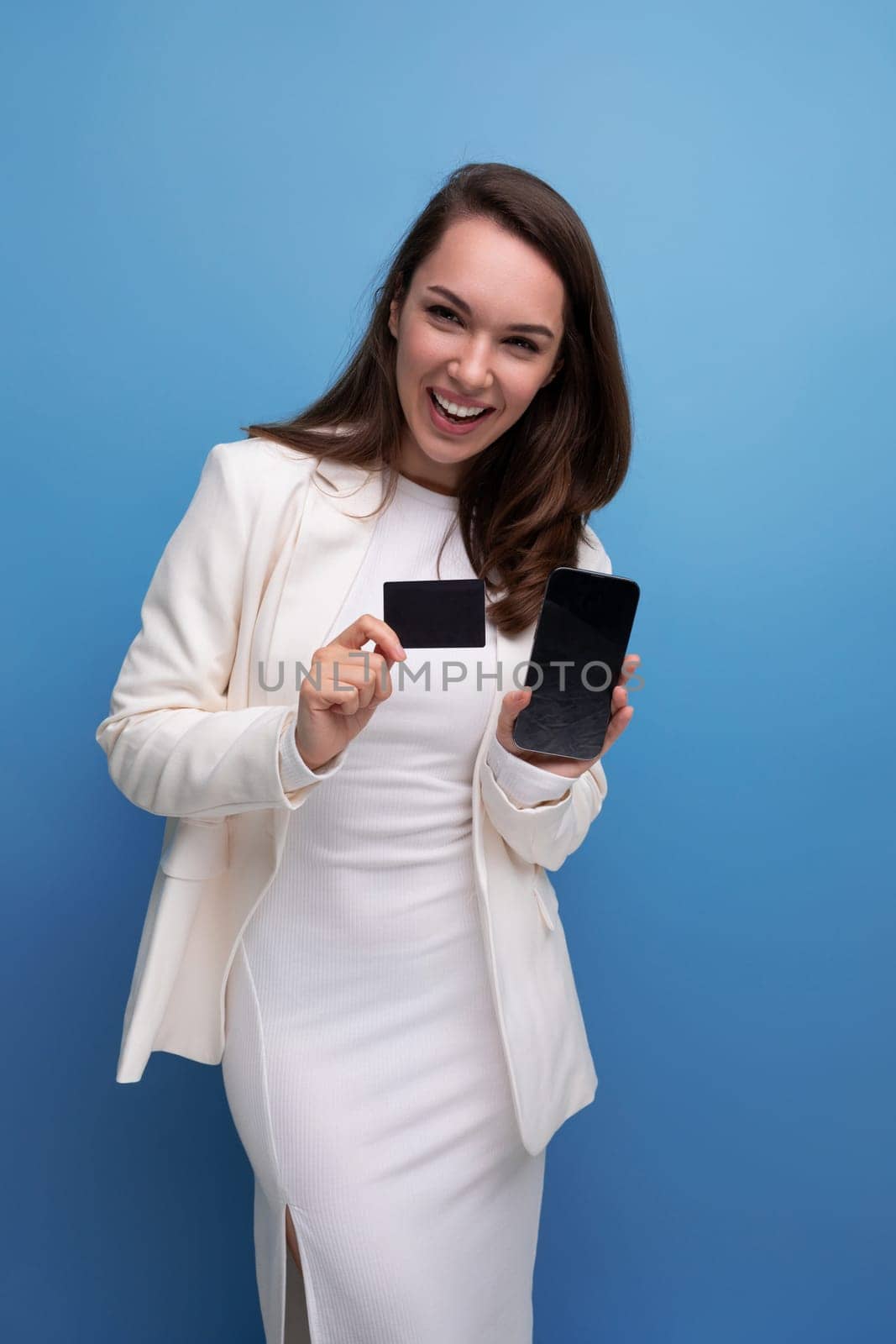 well-groomed brunette woman in office dress with card mockup.