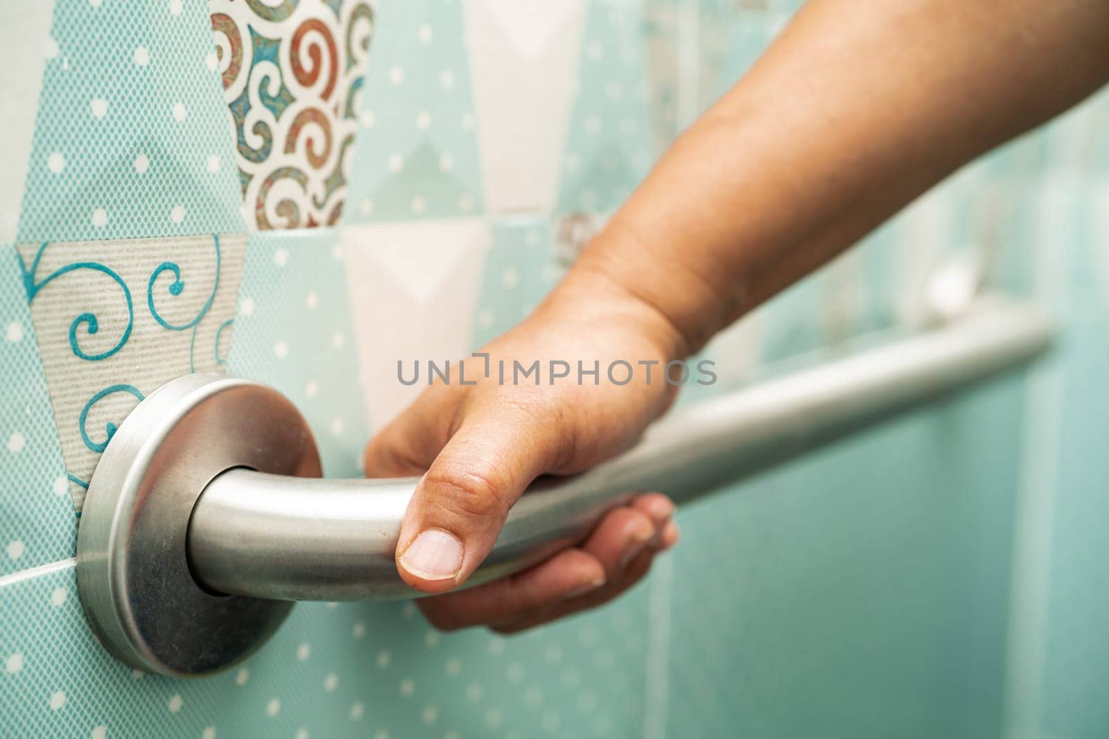 Asian elderly woman use bathroom handle security in toilet, healthy strong medical concept. by pamai