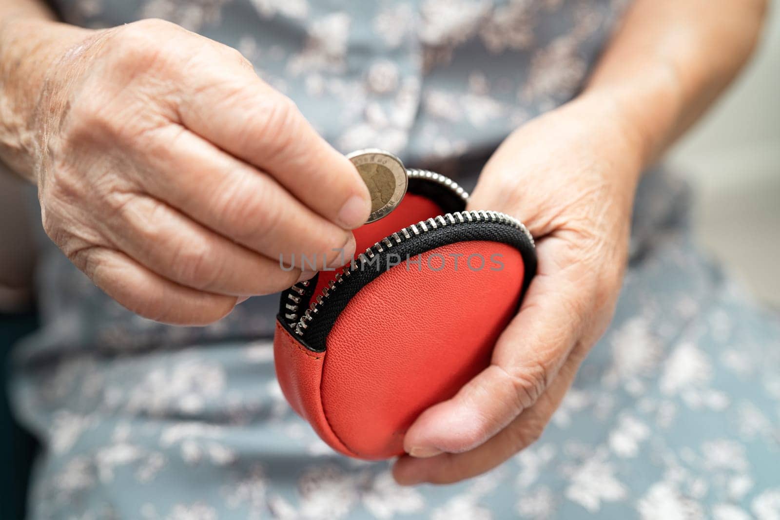 Asian senior woman holding counting coin money in purse. Poverty, saving problem in retirement.