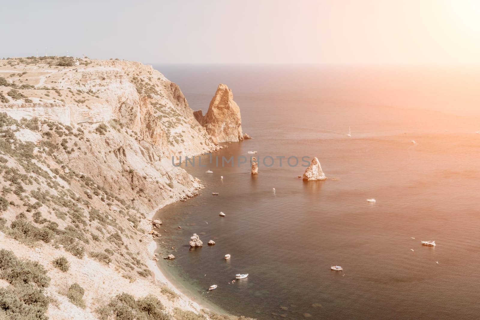 Aerial panoramic view of beautiful sunset above sea. Beautiful seascape. Sun glare, small waves on the water surface. Evening. Horizon. Nobody. No people. Copy space. Never-ending beauty of nature