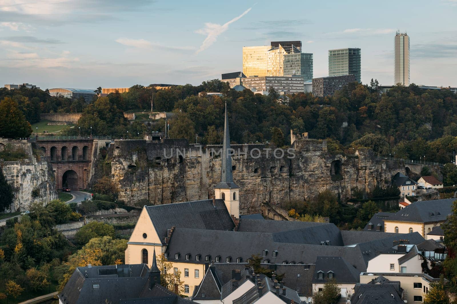 Dwelling constructions from three different periods in Luxemburg city. Combination of castle ruins with old town and modern skyscrapers on hill slope