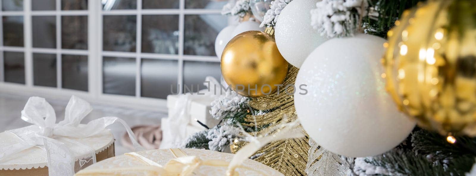 Christmas background. fir tree branch with cones and ornament. Christmas baubles in golden and white colours. Winter holidays concept. glitter Christmas baubles hanging from the branch by YuliaYaspe1979