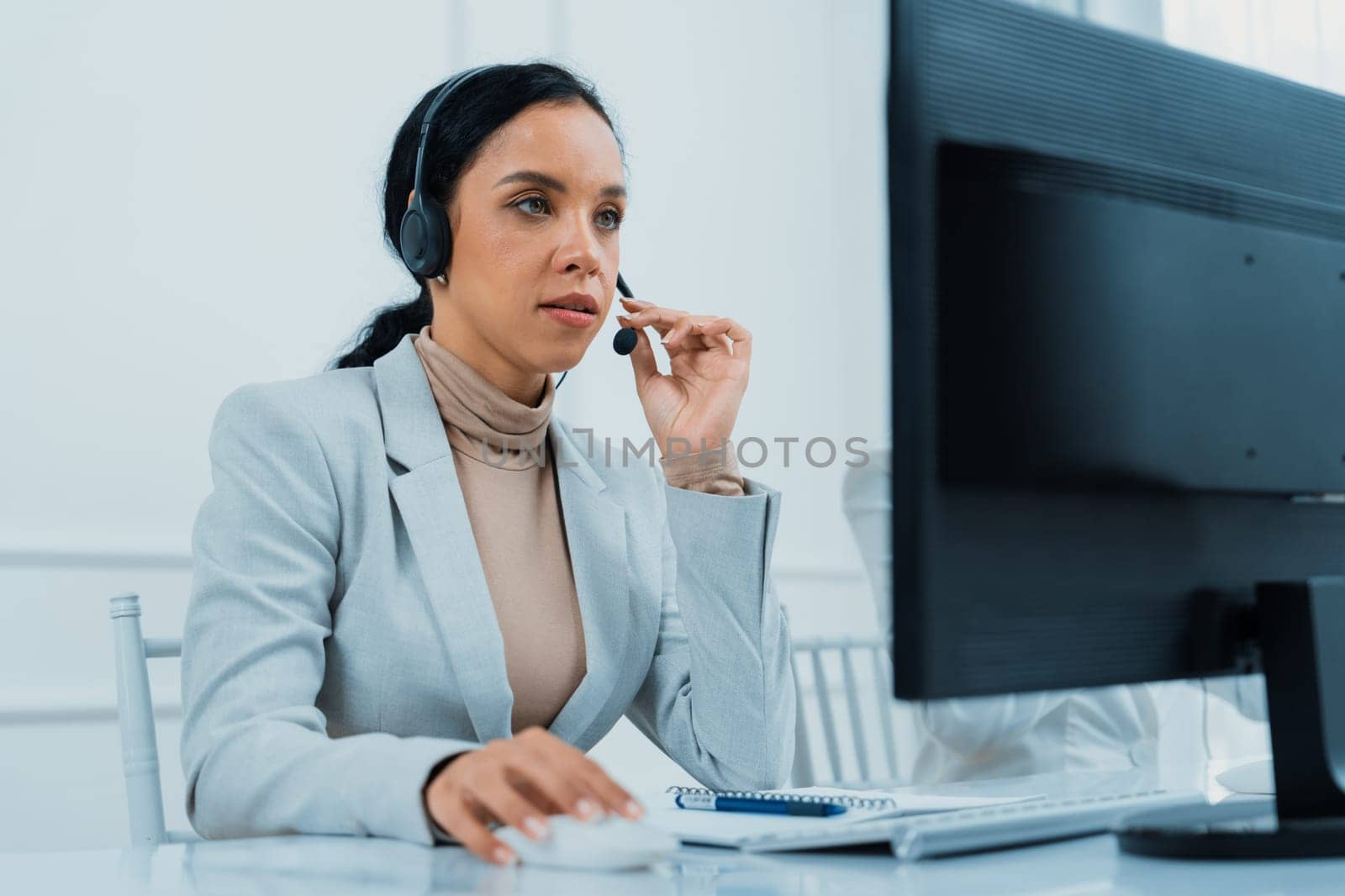 African American young businesswoman wearing headset working in office to support remote crucial customer or colleague. Call center, telemarketing, customer support agent provide service on video call