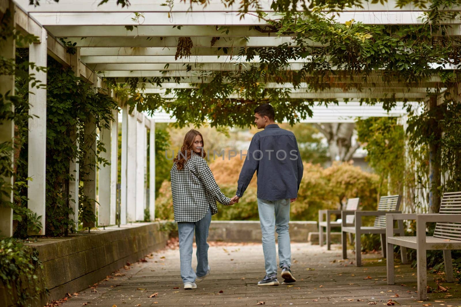 Young Cute Female Hugs Boyfriend. In Autumn Outdoor. Lovers Walking in Park. Attractive Funny Couple. Lovestory in Forest. Man and Woman. Cute Lovers in the Park. Family Concept. Happy Couple.