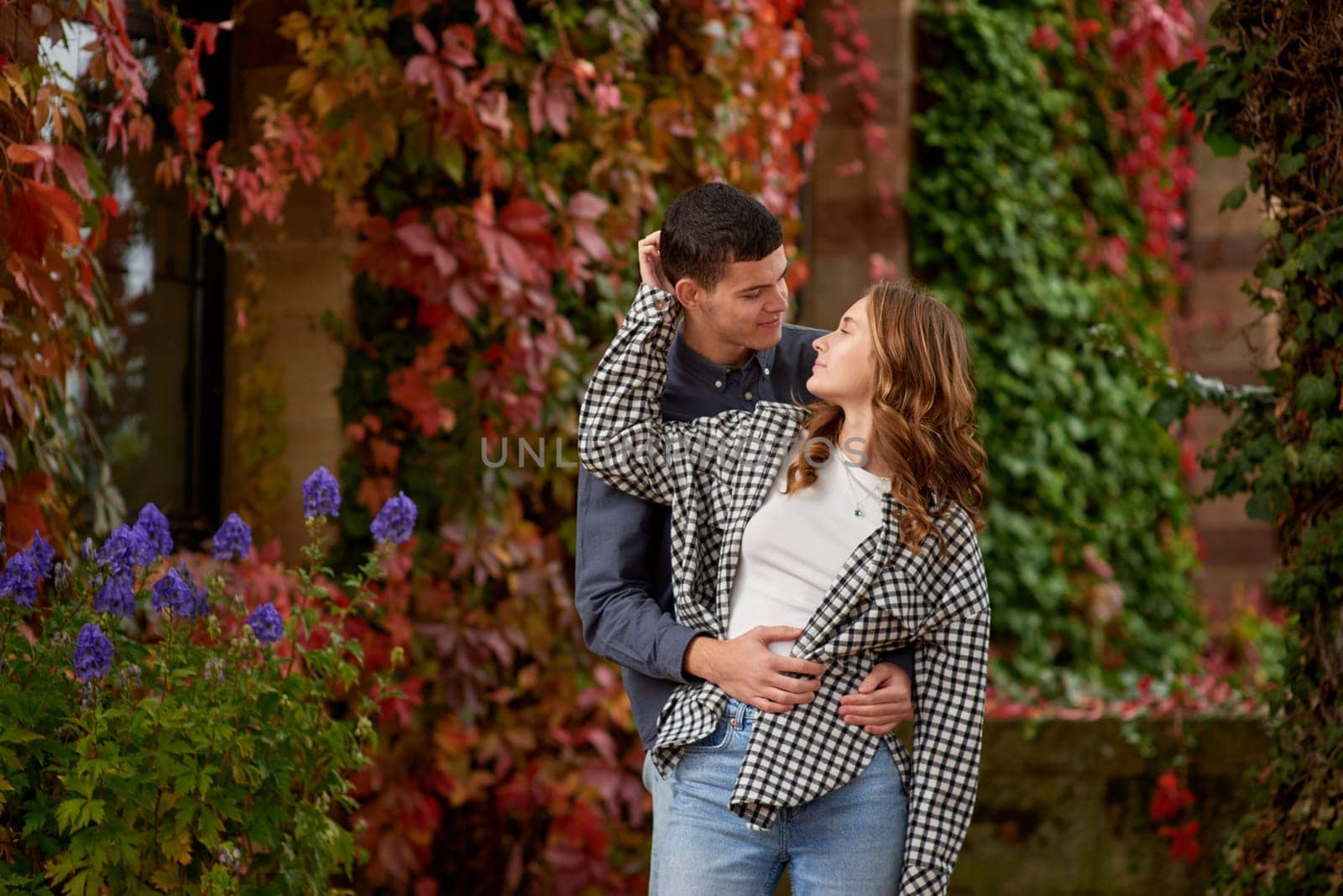 Young Cute Female Hugs Boyfriend. In Autumn Outdoor. Lovers Walking in Park. Attractive Funny Couple. Lovestory in Forest. Man and Woman. Cute Lovers in the Park. Family Concept. Happy Couple.