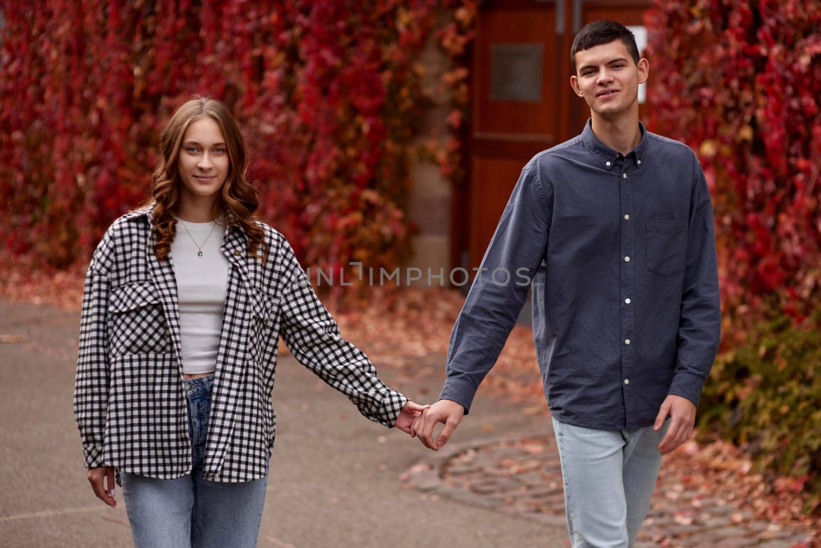 Young Cute Female Hugs Boyfriend. In Autumn Outdoor. Lovers Walking in Park. Attractive Funny Couple. Lovestory in Forest. Man and Woman. Cute Lovers in the Park. Family Concept. Happy Couple.