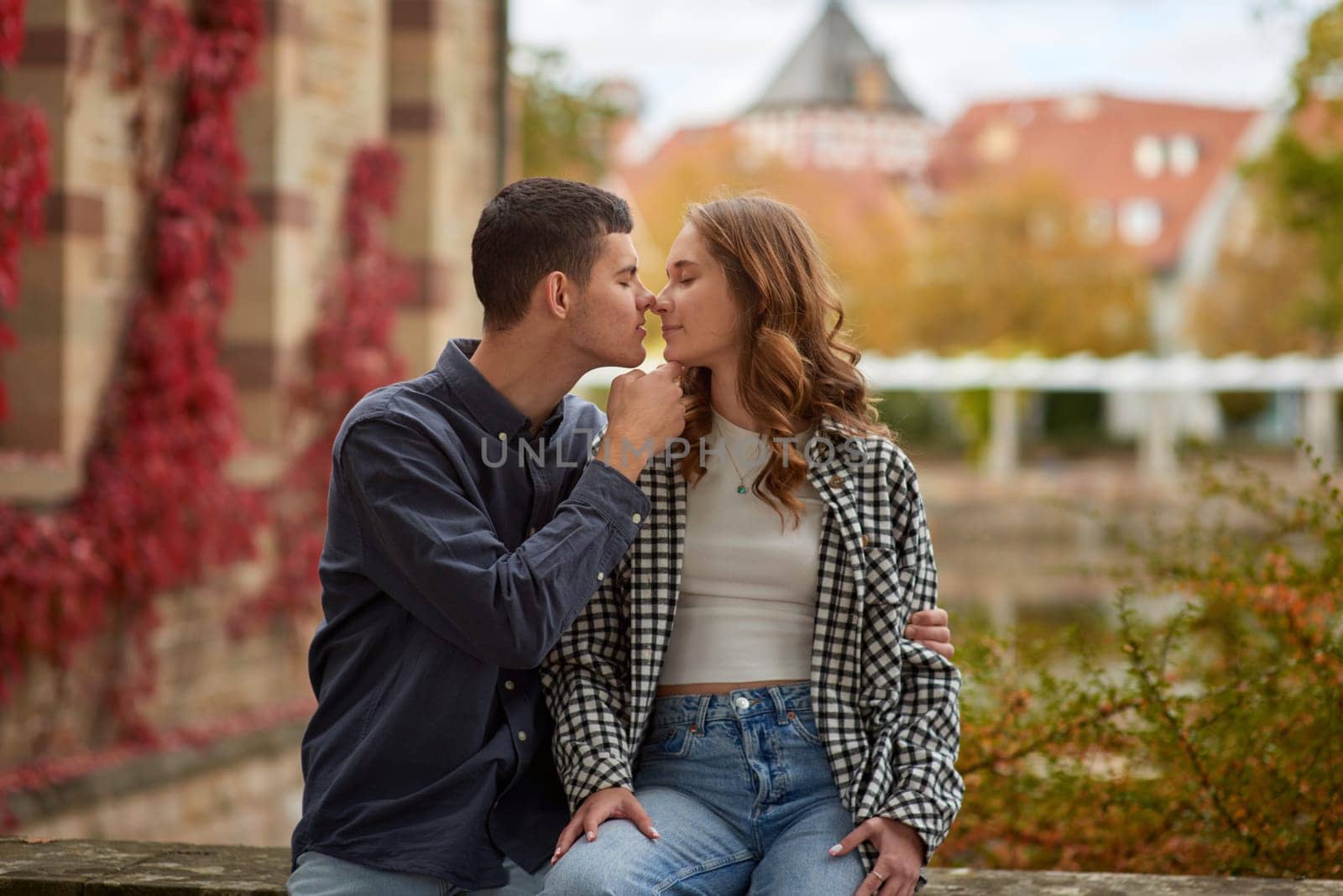 Young Cute Female Hugs Boyfriend. In Autumn Outdoor. Lovers Walking in Park. Attractive Funny Couple. Lovestory in Forest. Man and Woman. Cute Lovers in the Park. Family Concept. Happy Couple.