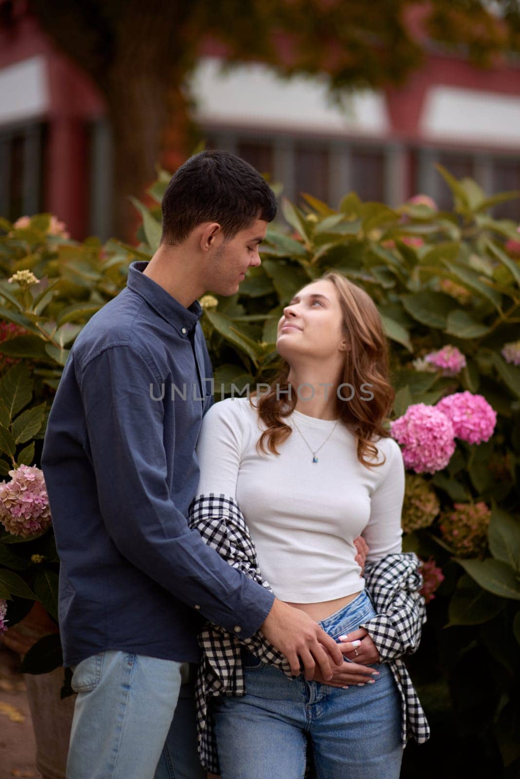 Warm Embrace of Teen Love in the Autumn Park. Capturing Teen Moments: Love Blossoms in Autumn's Embrace. Teenagers in Love: Embracing the Autumn Vibe by Andrii_Ko