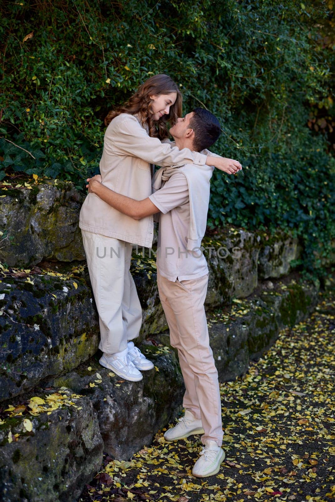 Warm Embrace of Teen Love in the Autumn Park. Capturing Teen Moments: Love Blossoms in Autumn's Embrace. Teenagers in Love: Embracing the Autumn Vibe by Andrii_Ko