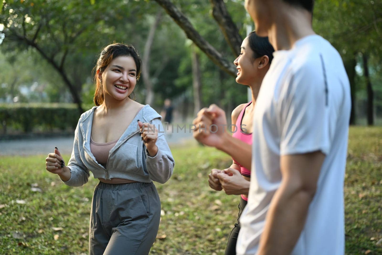 Group of fit healthy friends exercising together in the city park. Healthy Lifestyle concept.