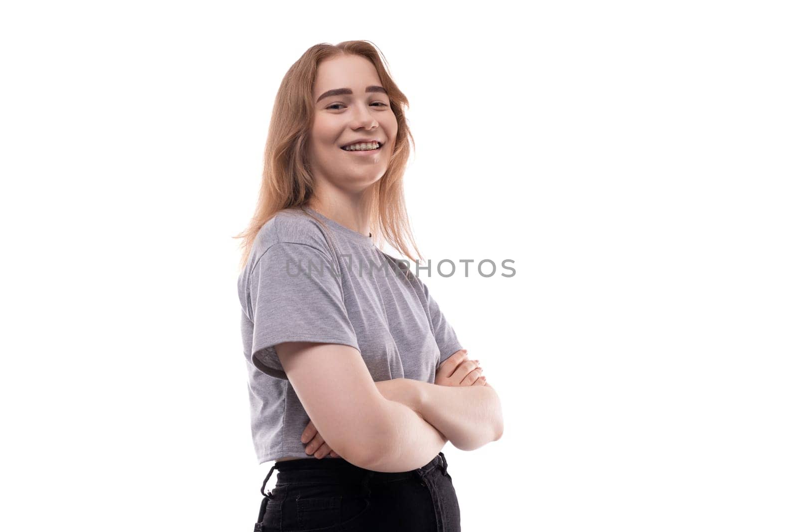 Cute teenage girl with blond hair on a white background.