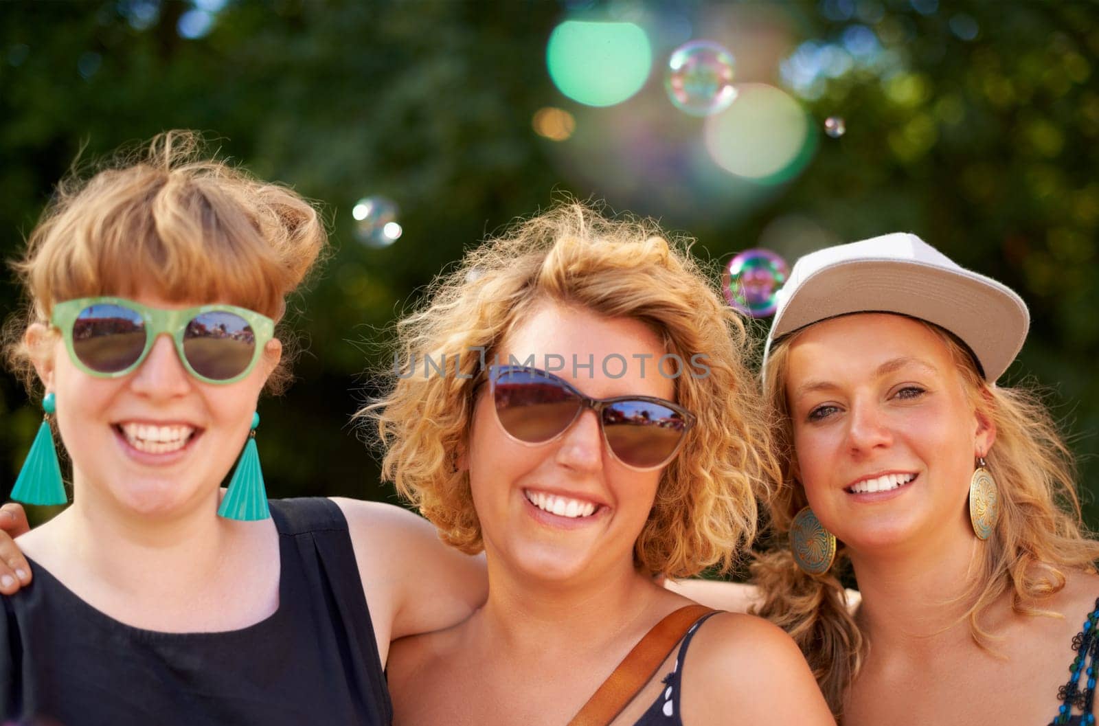 Portrait, outdoor and women with party, concert and social event with music festival, happiness and summer. Face, people and friends with lens flare, sunshine and weekend break with joy and smile.