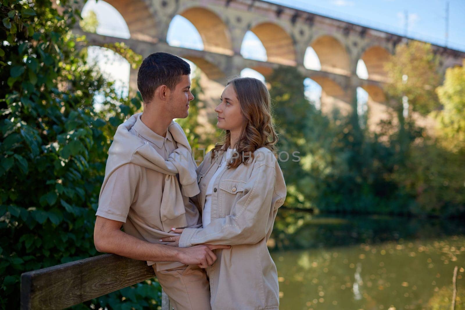 Young Cute Female Hugs Boyfriend. In Autumn Outdoor. Lovers Walking in Park. Attractive Funny Couple. Lovestory in Forest. Man and Woman. Cute Lovers in the Park. Family Concept. Happy Couple.