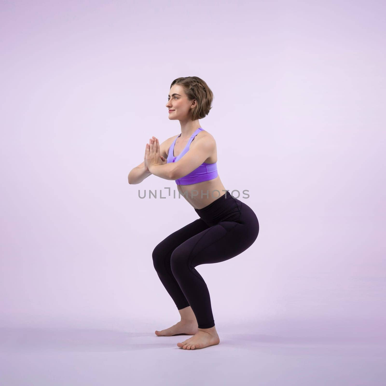 Full body length gaiety shot athletic and sporty woman doing healthy and meditative yoga exercise workout posture on isolated background. Healthy active and body care lifestyle