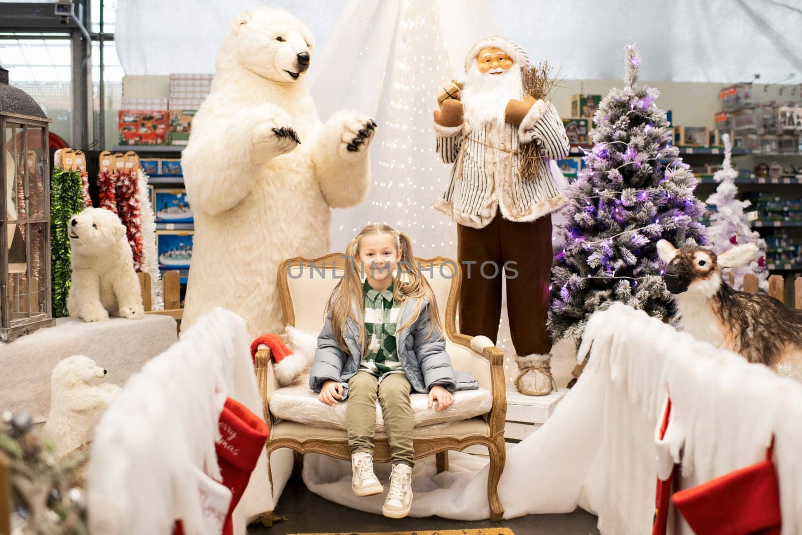 A girl visiting Santa Claus in a shop