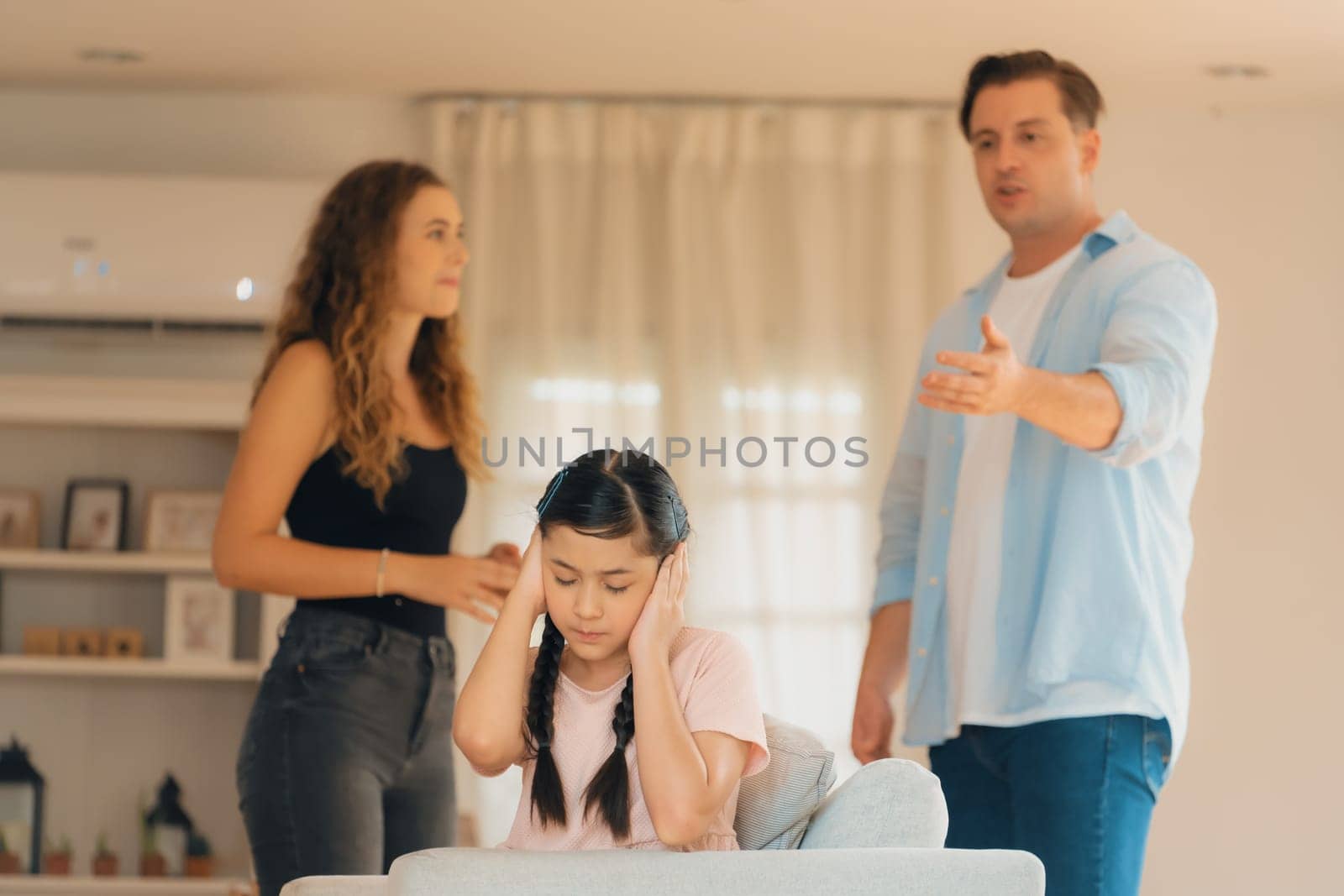 Young girl trapped in the middle of tension by her parent argument. Synchronos by biancoblue