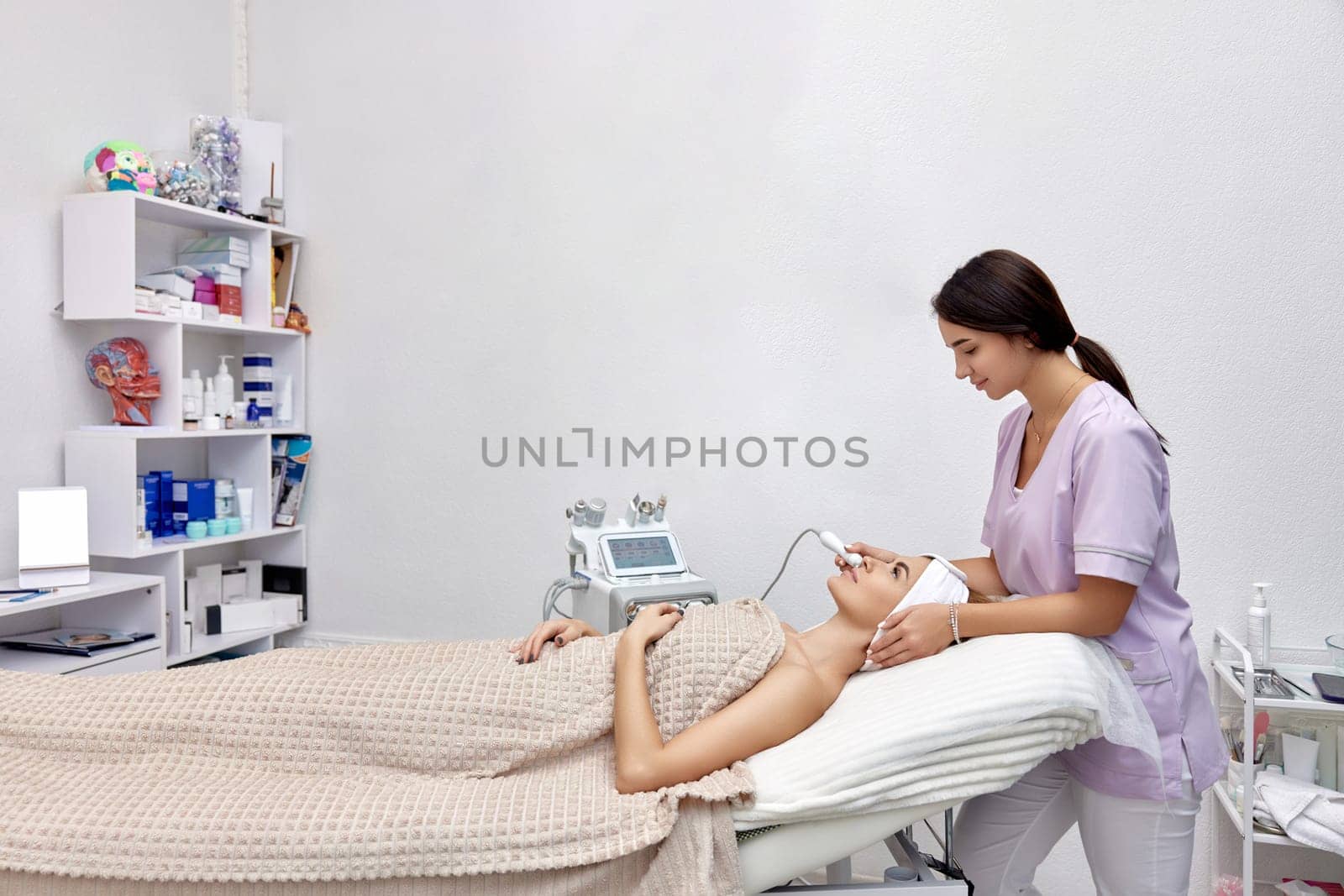 cosmetologist doing anti aging procedure in beauty salon