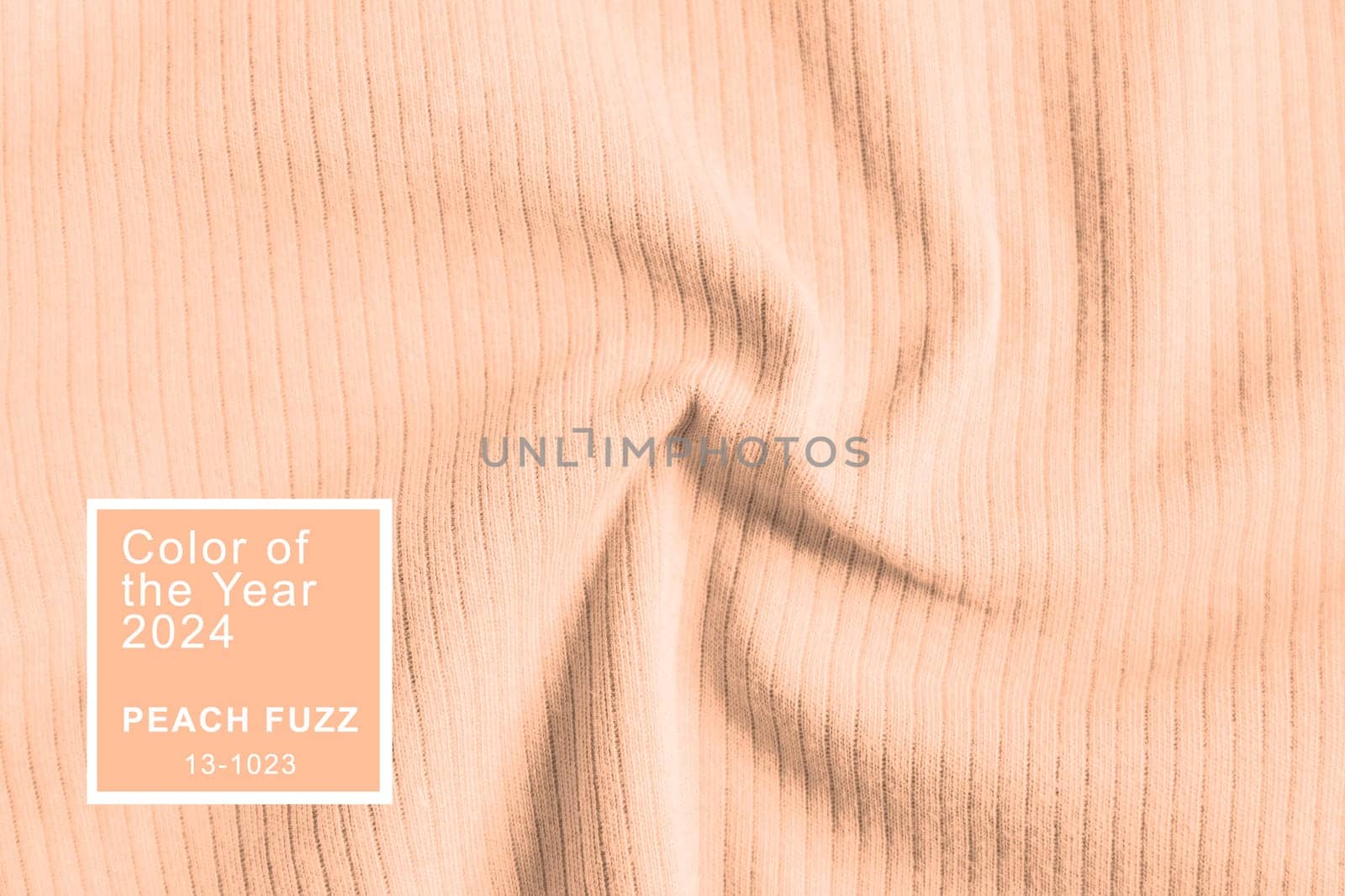 Peach Fuzz color of the year 2024. Waved ribbed cotton fabric texture pastel orange color . Close up rib cotton cloth and textiles pattern. Natural organic fabrics texture background