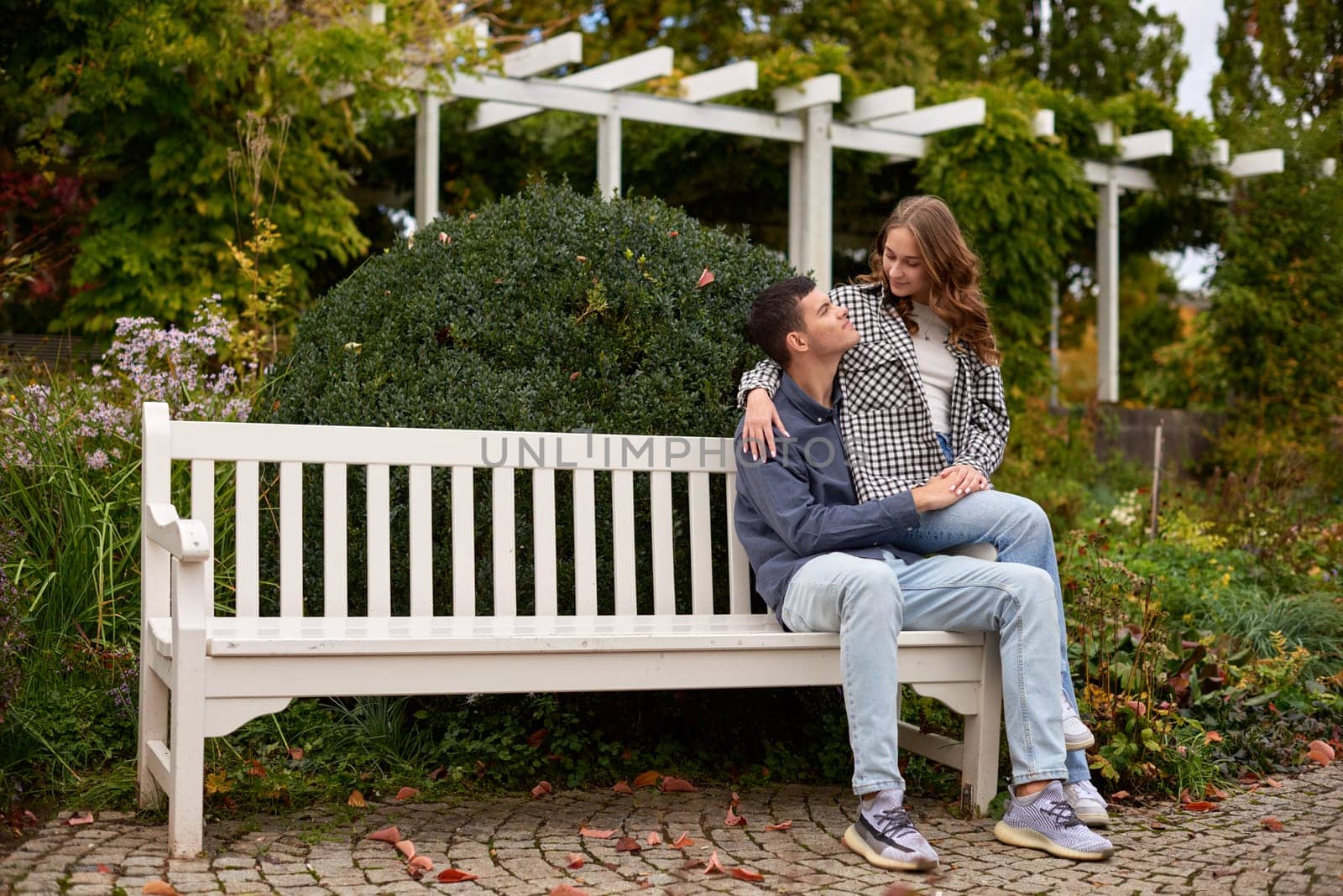 Warm Embrace of Teen Love in the Autumn Park. Capturing Teen Moments: Love Blossoms in Autumn's Embrace. Teenagers in Love: Embracing the Autumn Vibe by Andrii_Ko