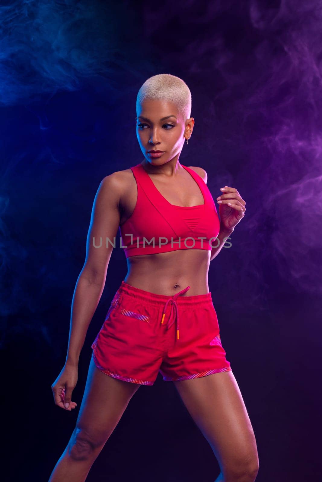 Sporty fit woman, athlete with dumbbells make fitness exercises on black background. Download cover for music collection for fitness classes. Sports recreation. Beautiful black young woman