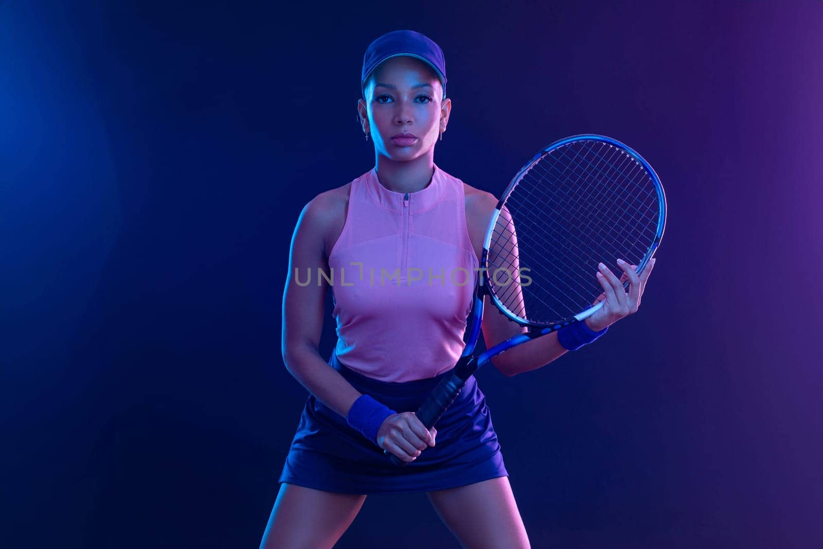 Tennis player woman with racket on tournament. Girl athlete with tenis racket on court with neon colors. Sport concept. Download a high quality photo for design of a sports app or tour events. by MikeOrlov