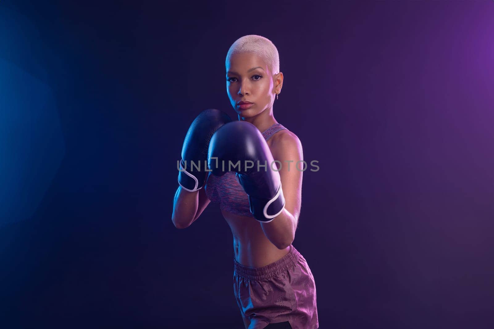 The Boxing. Brazilian woman boxer. Sportsman muay thai boxer fighting in gloves. Isolated on black background. Copy Space