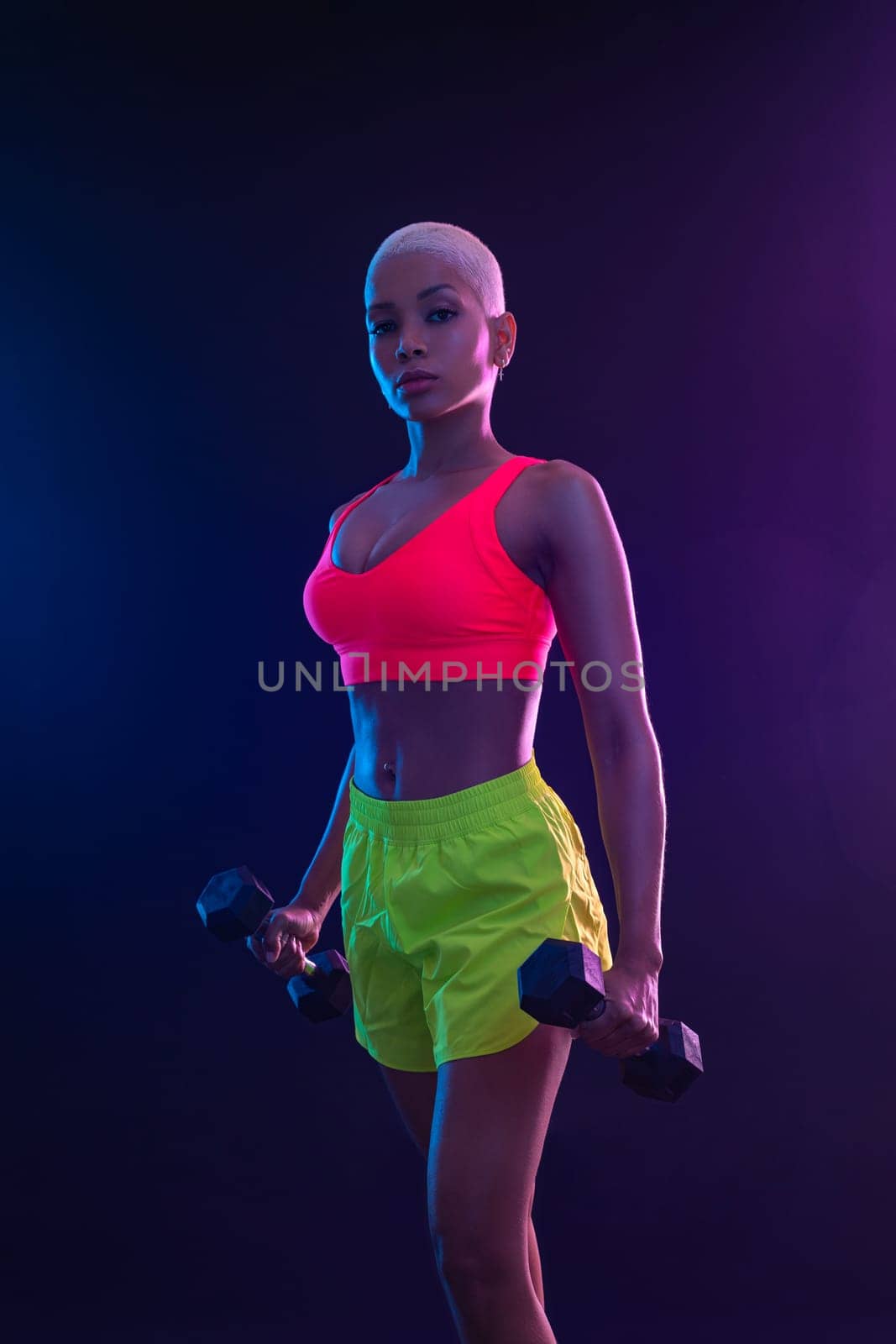 Sporty fit woman, athlete with dumbbells make fitness exercises on black background. Download cover for music collection for fitness classes. Sports recreation. Beautiful black young woman. by MikeOrlov