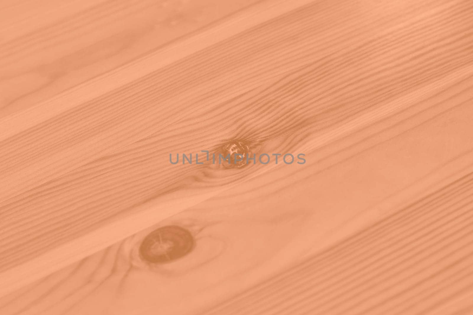 Peach Fuzz color wood texture monochrome background. Wood texture with natural pattern. Color of the year 2024. High quality photo